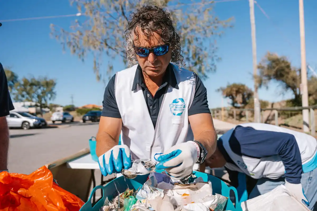 Coastal Waste Warriors volunteer sorting through waste